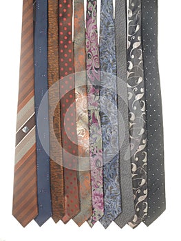 Variety of men`s ties isolated on white background. Ties of various colors and patterns