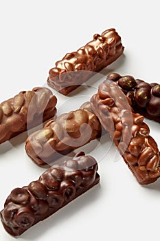 Variety of milk and dark chocolate bars with nuts on white