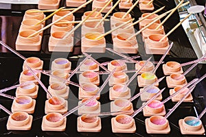 A variety of Modeling Gel in different colors in plastic jars. They are used to strengthen natural nails, in a technique without