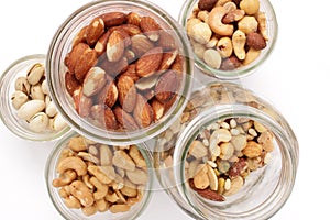 Variety of nuts in glass jars above