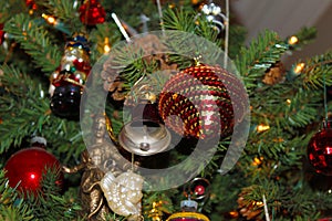 A variety of old fashioned ornaments and pine cones on a Christmas Tree