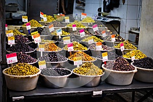 Variety of olives for sale on Suq arabic price tags photo