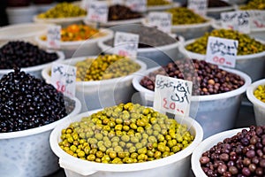 Variety of olives for sale on Suq arabic price tags photo