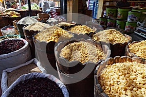 Variety organic groats in barrel on sale on a farmers market, ecological cereal products, pasta, wheat, millet