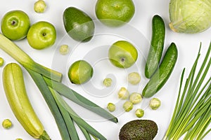 Variety of organic healthy vegetables only green color on white background. Top view of ripe, raw and juice vegetables.