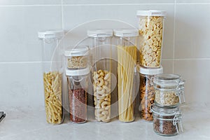 A variety of pasta, rice, cereals, nuts in containers-cans. The concept of proper convenient rational storage of food in the