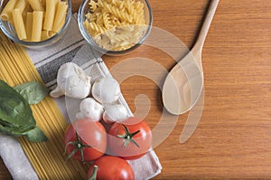 Variety of pasta with tomatoes, basil, mushrooms and garlic