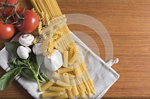 Variety of pasta with tomatoes, basil, mushrooms and garlic