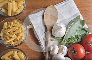 Variety of pasta with tomatoes, basil, mushrooms and garlic