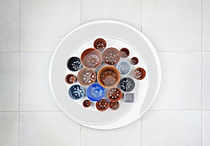 Variety of plastic pots displayed on white table, view above