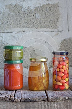 Variety of preserved food in glass jars - pickles, jam, marmalade, sauces, ketchup. Preserving vegetables and fruits. Fermented fo