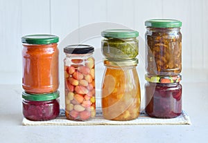 Variety of preserved food in glass jars - pickles, jam, marmalade, sauces, ketchup. Preserving vegetables and fruits. Fermented fo