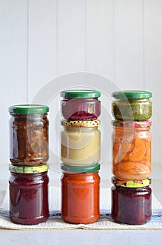 Variety of preserved food in glass jars - pickles, jam, marmalade, sauces, ketchup. Preserving vegetables and fruits. Fermented fo