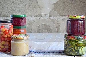 Variety of preserved food in glass jars - pickles, jam, marmalade, sauces, ketchup. Preserving vegetables and fruits. Fermented fo