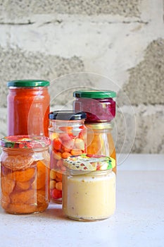 Variety of preserved food in glass jars - pickles, jam, marmalade, sauces, ketchup. Preserving vegetables and fruits. Fermented fo