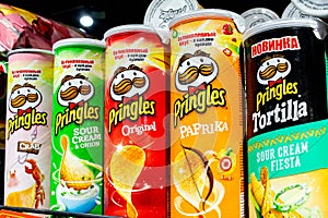 Minsk, Belarus, March 13, 2019: Variety of Pringles Potato Chips display in the supermarket shelve. Pringles chips are made by Pro