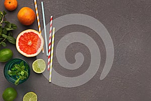 Variety of ripe citruses on gray background, top view