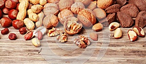 Variety of shelled and whole nuts in a banner photo