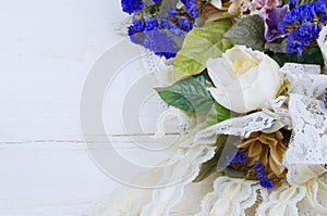A variety of silk and dried flowers combines with lace is a feminine image good for anniversary, wedding, mother`s day or birthday