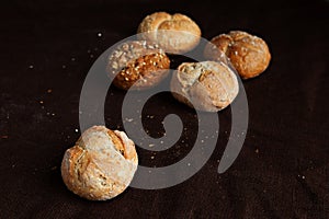 Variety of small breads with seeds isolated on black background