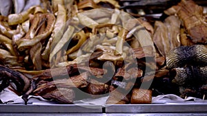 Variety of smoked sea fishes and other seafood on the counter in a fish shop