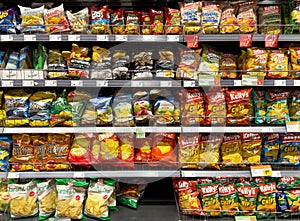 Variety of snack chips displayed on grocery store shelves