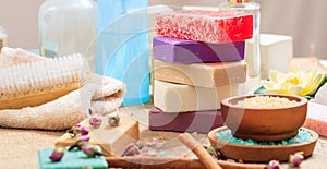 Variety of soap bars on wooden background