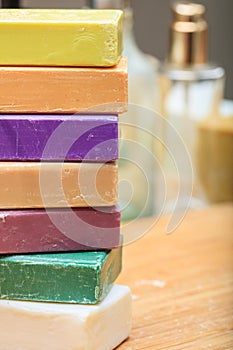 Variety of soap bars on wooden background