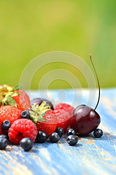 Variety of soft fruits, strawberries, raspberries, cherries, blueberries on table