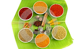 Variety of Spices on banana leaves photo