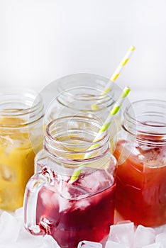 Variety of Tasty Juices in Glass Jars Mugs Healthy Beverages Drinks White Background Vertical