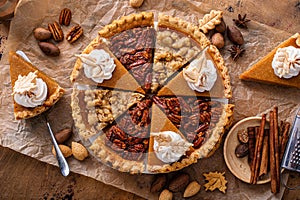 Variety of Thanksgiving pie slices on parchment paper