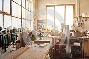 Variety of tools on workbenches in a woodworking shop