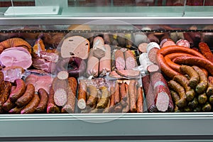 Variety of traditional european wurst, sausages, salamis and meats in a shop window