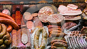 Variety of traditional european wurst, sausages, salamis and meats in a shop window