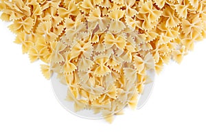 A variety of types and shapes of Italian pasta. Dry pasta bows farfalle .  Heap of bow tie macaroni isolated on white background