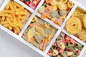 Variety of types and shapes of raw Italian pasta.