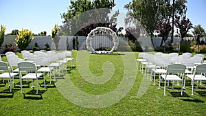 Variety of white folding chairs in the reception area of the marriage on the wedding ceremony.