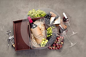 Variety of wine and snack set. Different types of grapes. Fresh ingredients on wooden background
