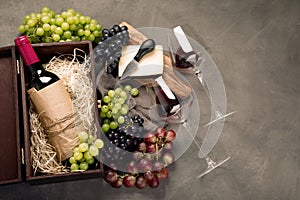 Variety of wine and snack set. Different types of grapes. Fresh ingredients on wooden background