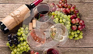 Variety of wine and snack set. Different types of grapes. Fresh ingredients on wooden background