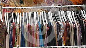 Variety of women`s clothing hanging on hangers in a clothing store. Fashion and Shopping Concept