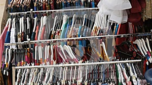 Variety of women`s clothing hanging on hangers in a clothing store. Fashion and Shopping Concept