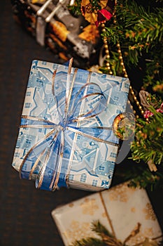 A variety of wrapped gifts under a festively decorated Christmas tree. Life style