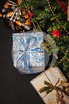 A variety of wrapped gifts under a festively decorated Christmas tree. Life style