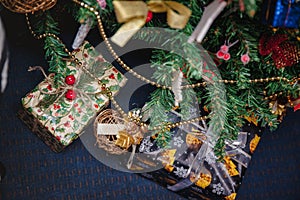 A variety of wrapped gifts under a festively decorated Christmas tree. Life style