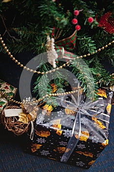 A variety of wrapped gifts under a festively decorated Christmas tree. Life style