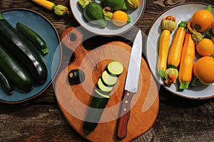 Variety zucchini, squash on a wooden background, top view. Vegetarian diet food concept. Cooking ingredients