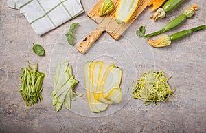 Variety Zucchini vegetable noodles - green zoodles or courgette spaghetti on plate over gray background. Clean eating, raw