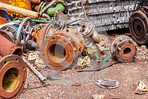 Various aged rusted parts of obsolete equipment at junkyard